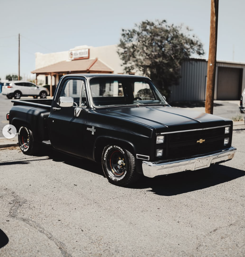 Blacked out lowered Chevy C10 stepside outside the shop