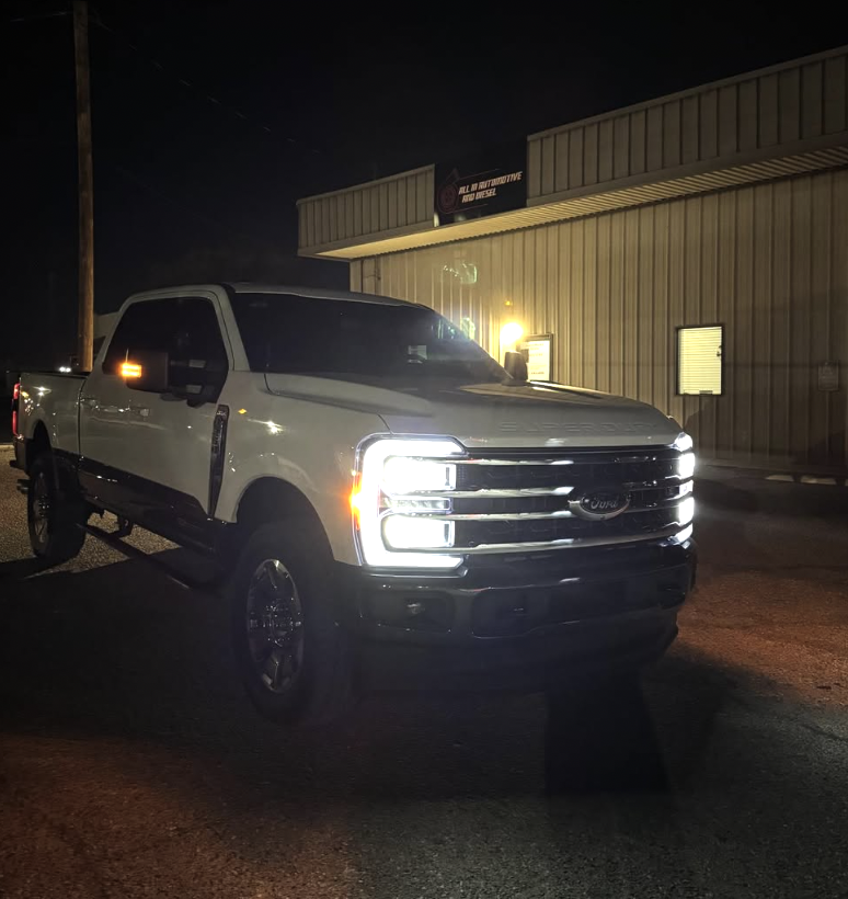Ford Super Duty with lights on at the shop at night